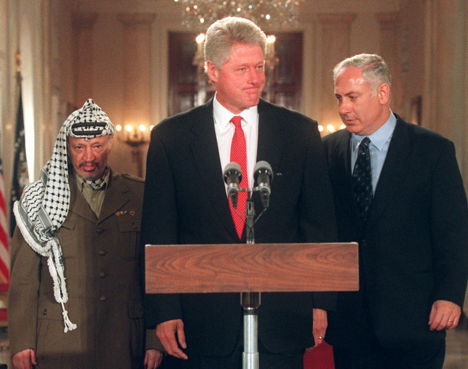 1996: Negotiates Middle East peace with Arafat, Netanyahu